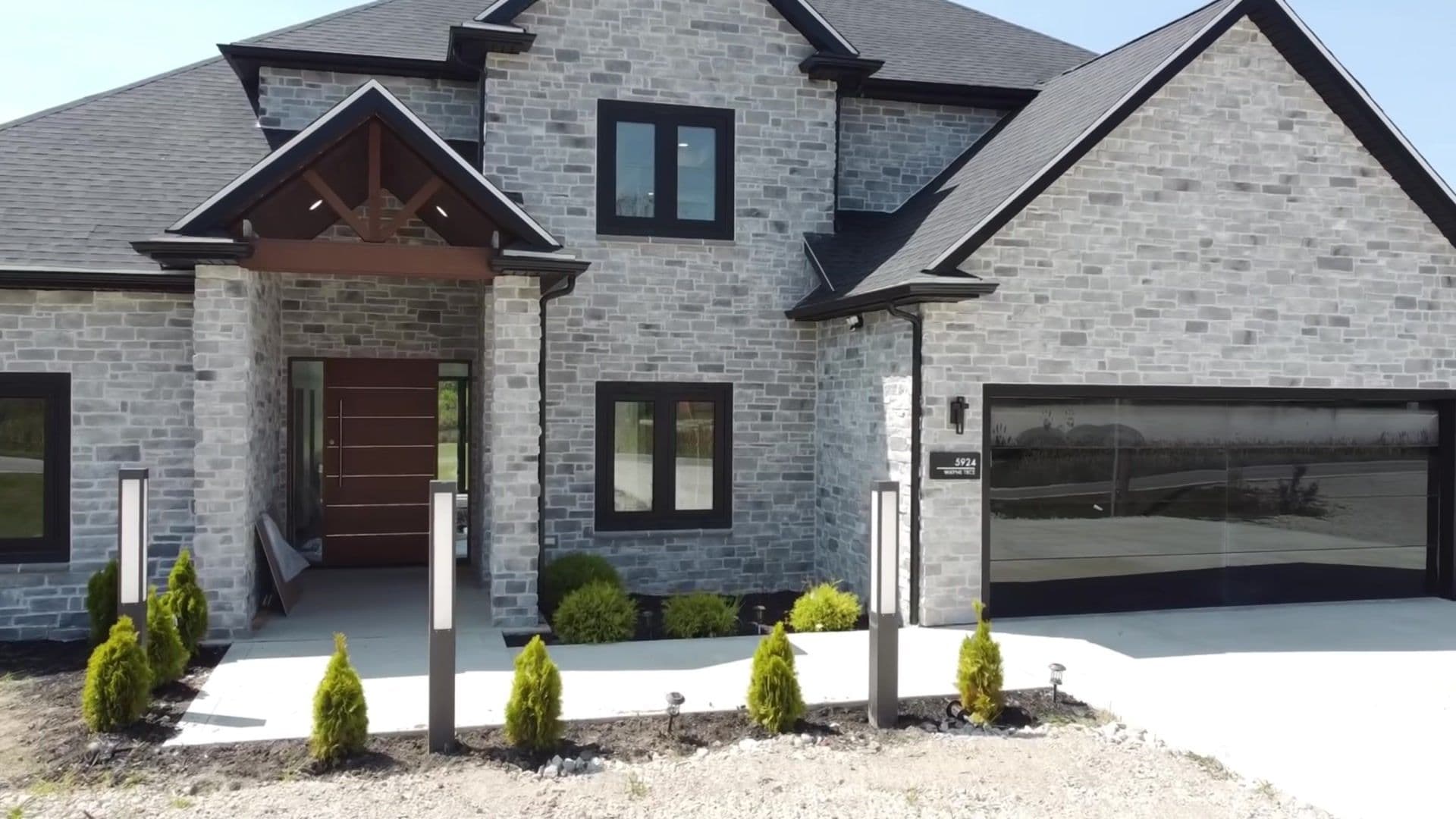 AriaLux Homes - gray stone custom home exterior